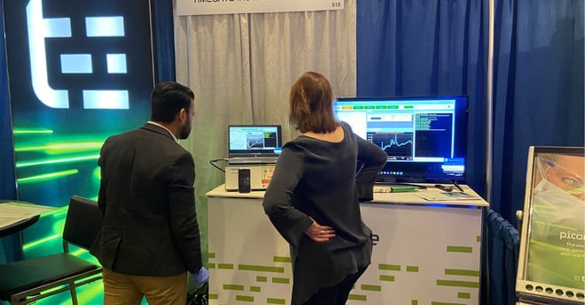 People watching instrument at IFPAC event booth