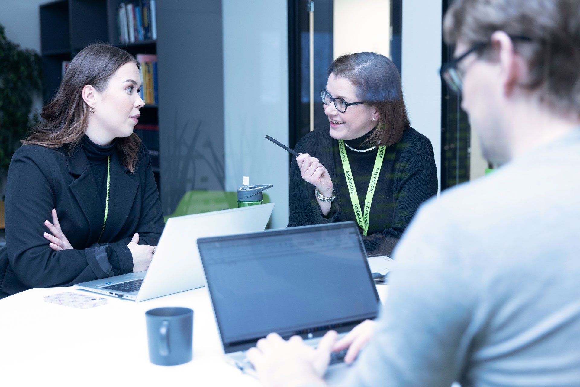 three-people-having-meeting-around-table
