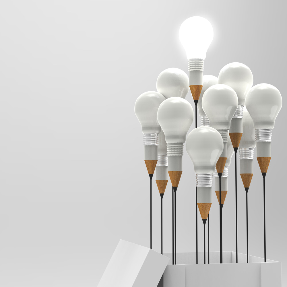 Pencils-and-light-bulbs-merged-hoovering-over-box
