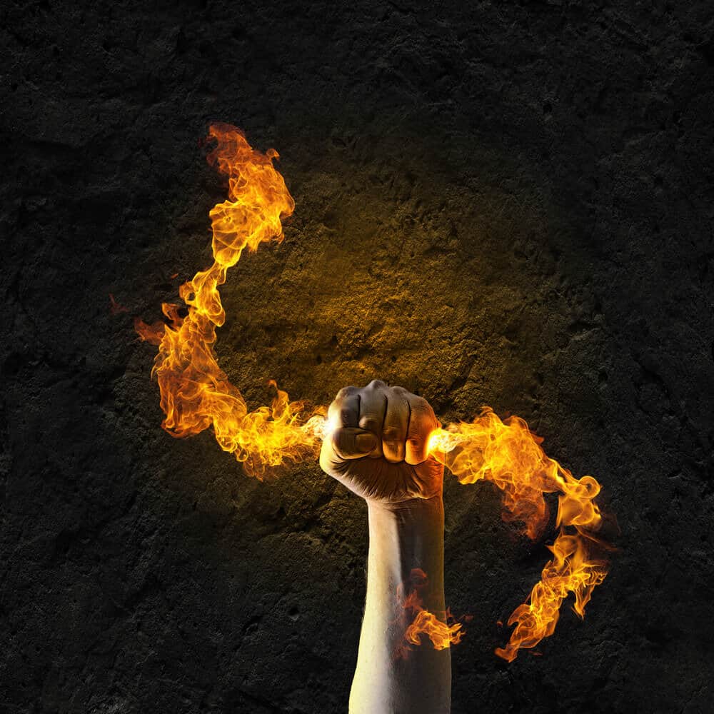 Human hand holding a flame.